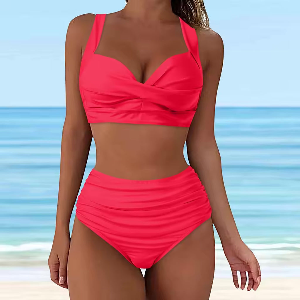 Bright coral high-waisted bikini with ruched detailing and sweetheart neckline on beach background