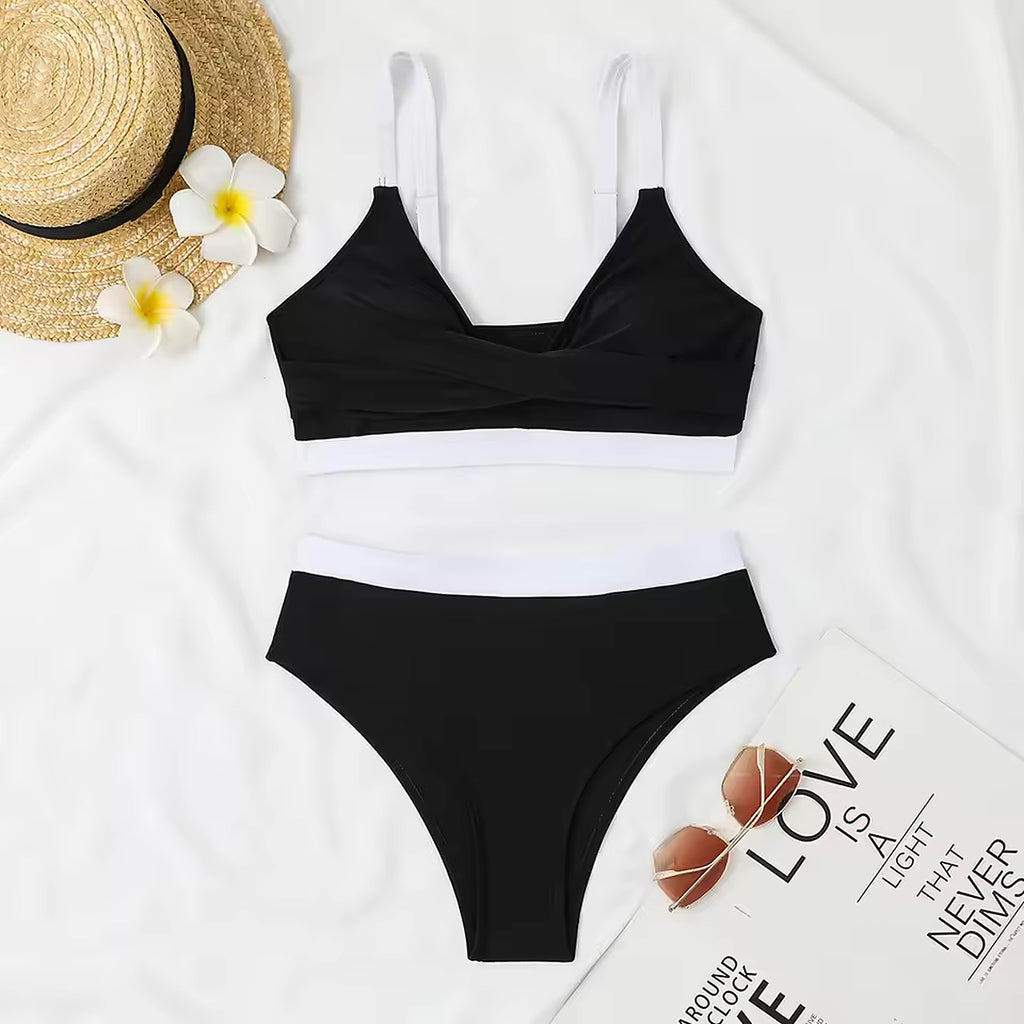 Black and white color-block bikini with white straps, styled with straw hat and tropical flowers