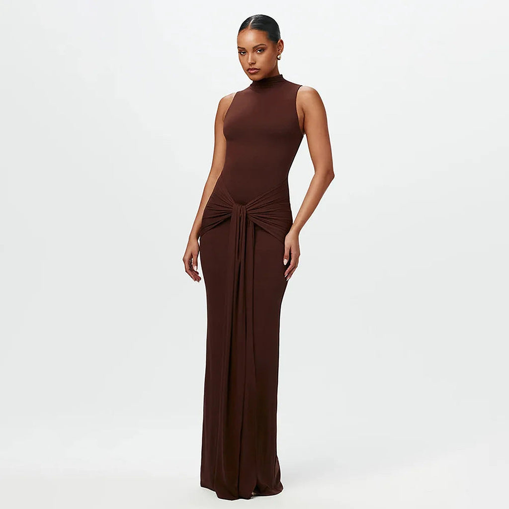 Brown high-neck one-piece swimsuit with twisted waist detail and long flowing skirt overlay