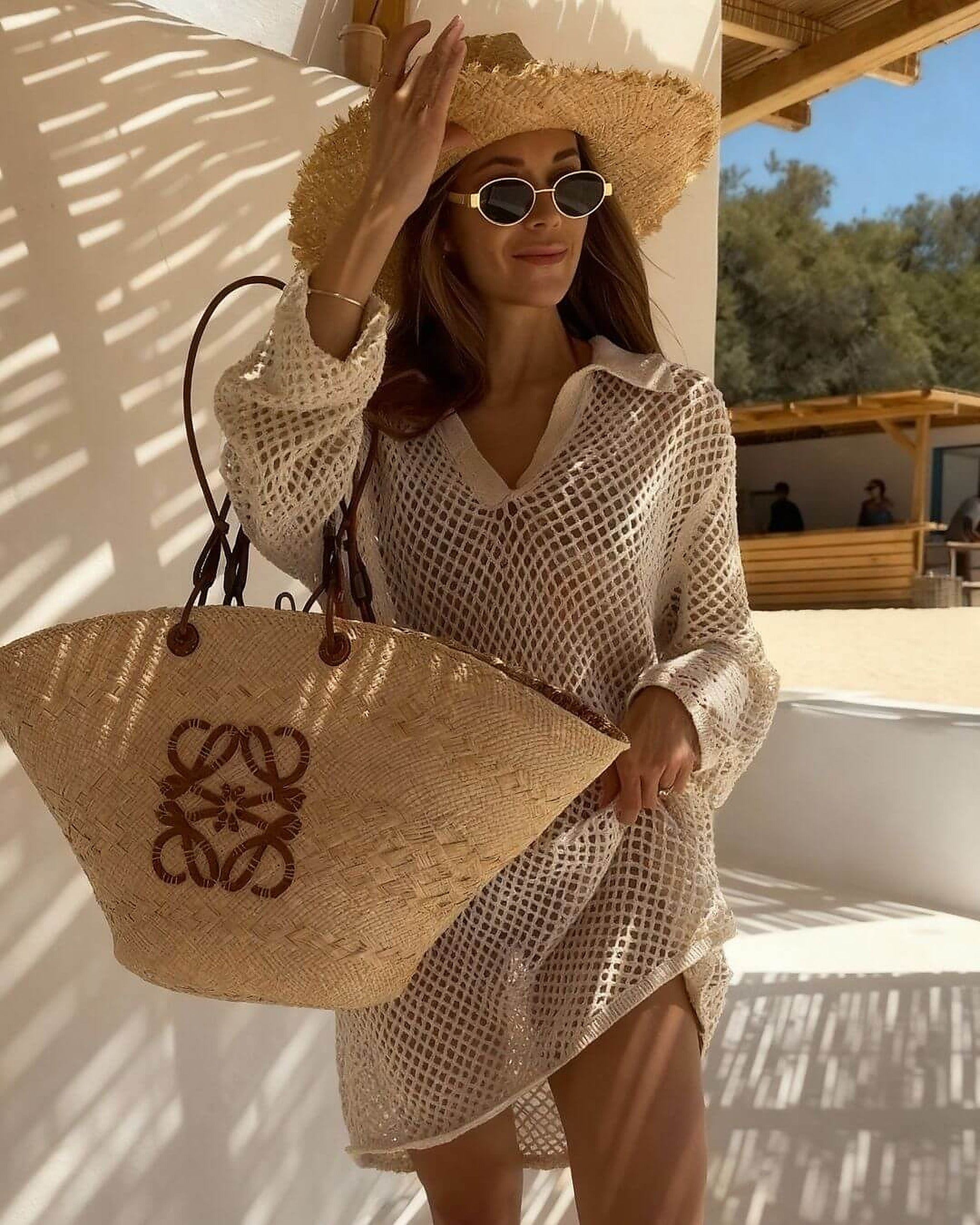 White crochet bikini cover-up with V-neckline styled at sunny poolside retreat