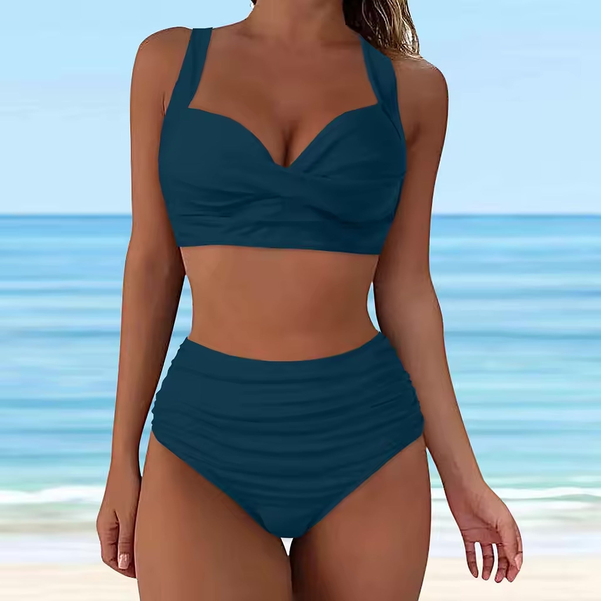 Deep teal bikini with sweetheart neckline and high-waisted ruched bottoms on beach model