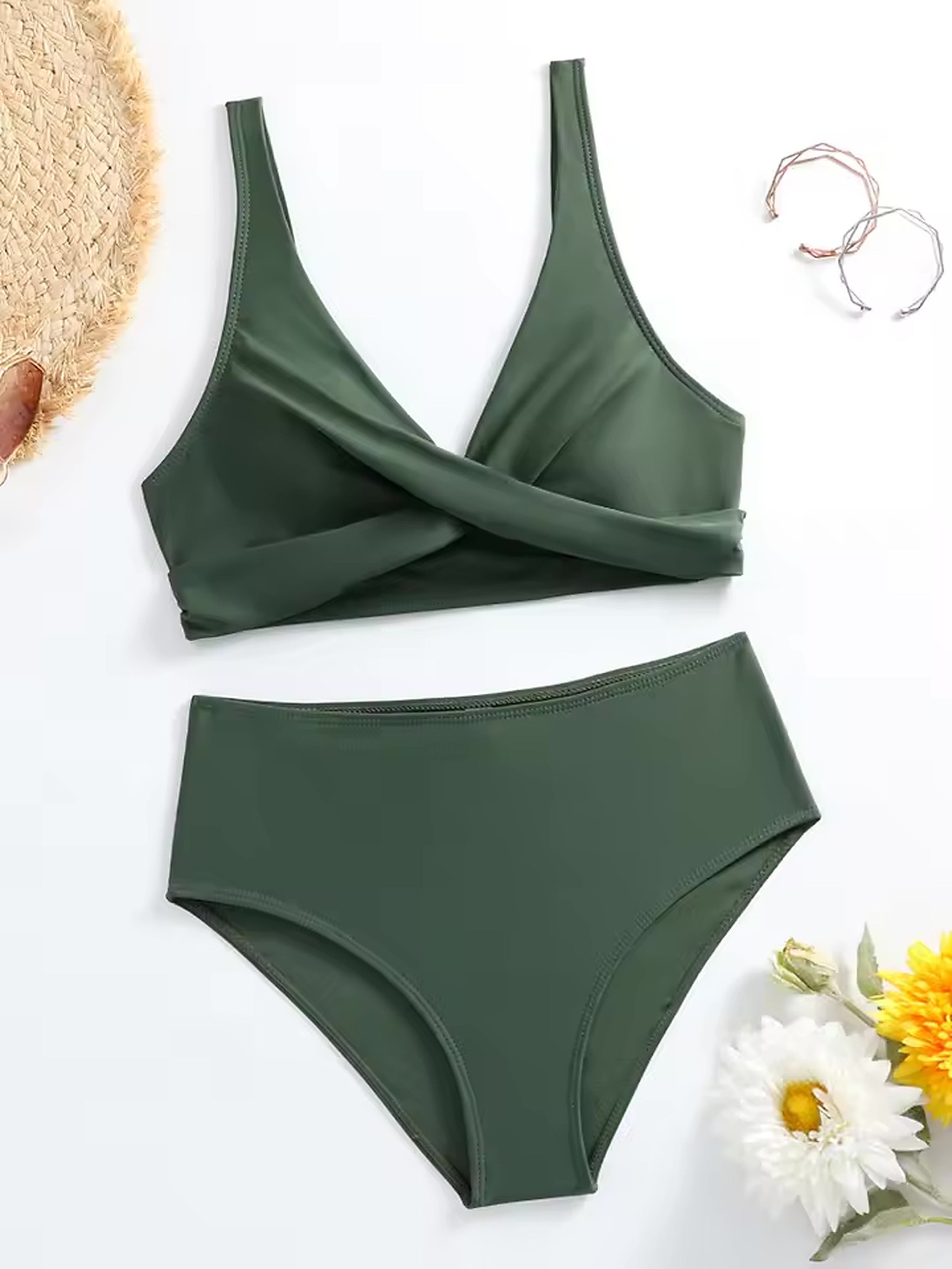 Olive green wrap bikini with high-waisted bottoms, styled flat lay with straw hat and flowers
